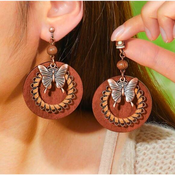 Clip on 2 3/4" brass and brown wood circle earrings with dangle butterfly - Picture 1 of 4
